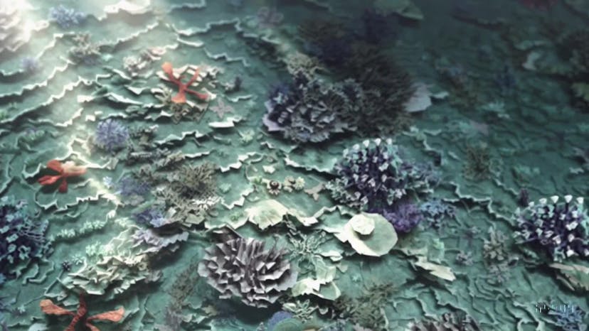 A gorgeously rendered papercraft world of a coral reef, rife with colorful fish and sea creatures.